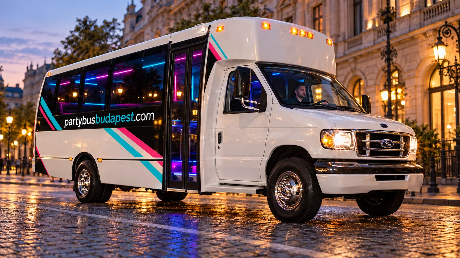 White compact party bus with turquoise and pink graphics on a Budapest street